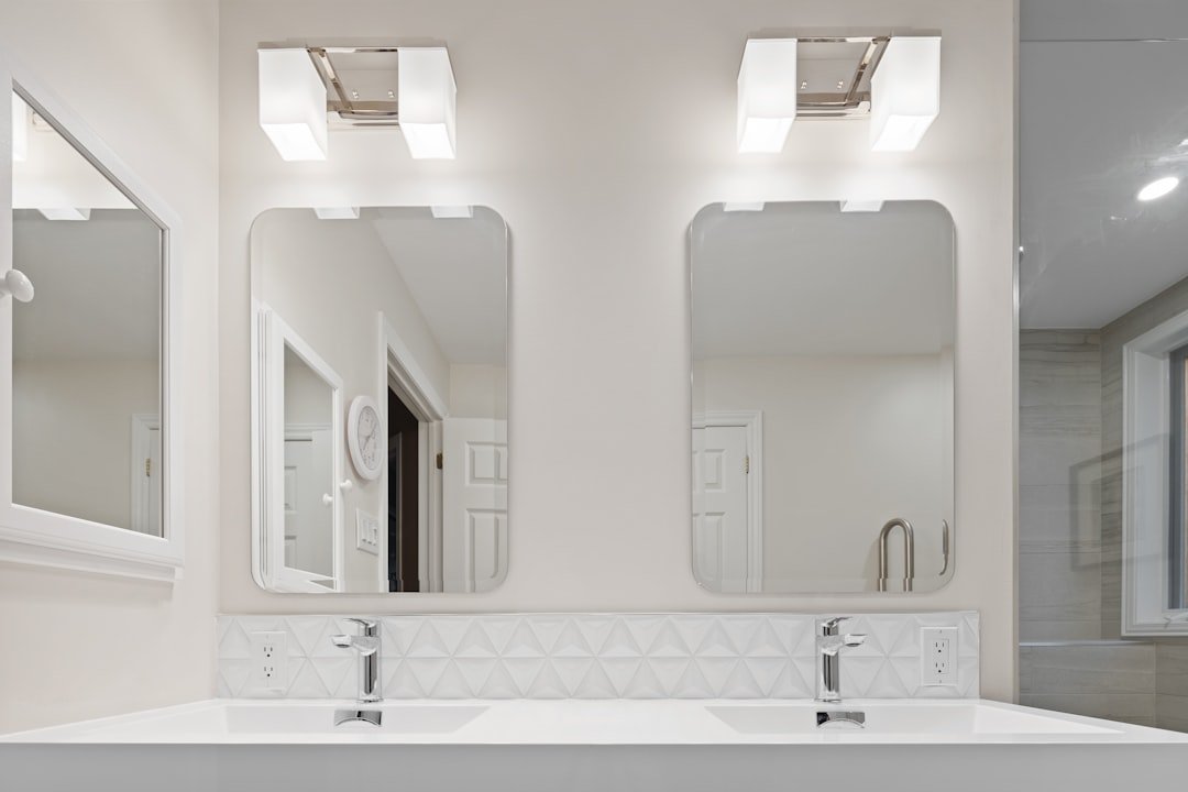 a-bathroom-with-a-couple-of-mirrors-cijoejyendc